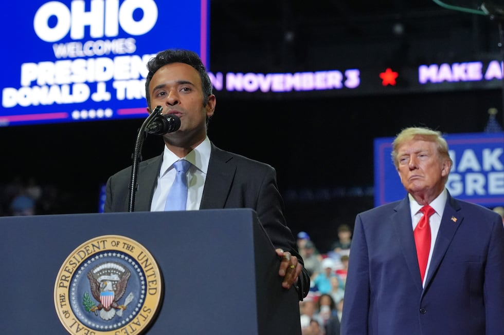 President Donald Trump listens as gubernatorial candidate Vivek Ramaswamy speaks at a campaign...