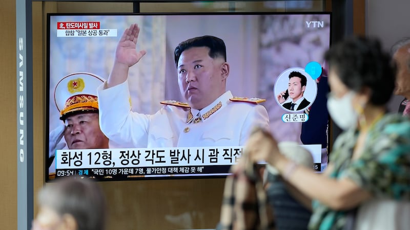 FILE - A TV screen showing a news program reporting about a North Korean missile launch with...
