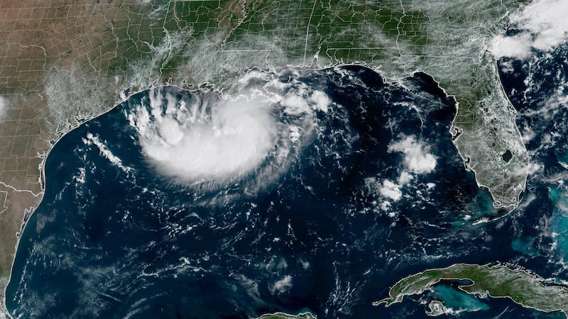 This satellite image released by NOAA shows Potential Tropical Cyclone Five forming over the...