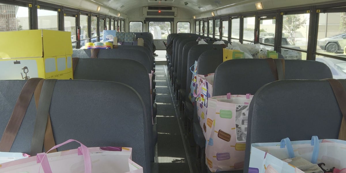 Hospital staff stuff a bus with school supplies for area students