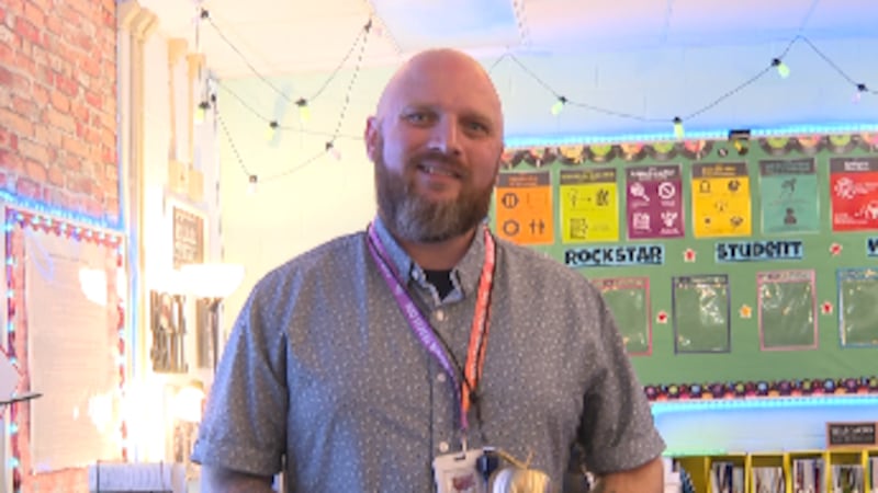 Third-grade teacher Chris Wade was honored with the Golden Apple Award after a student...