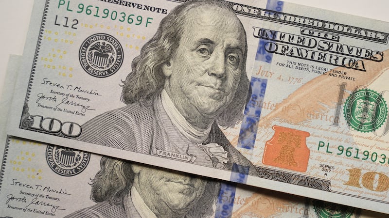 U.S. $100 bills are displayed for a photo in Dallas, Wednesday, Sept. 30, 2026. (AP Photo/LM...