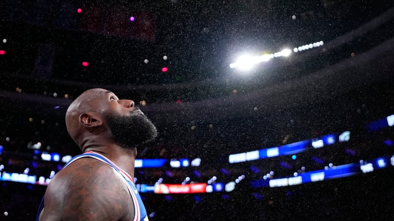 Philadelphia 76ers' LeBron James tosses chalk into the air before an NBA basketball game...